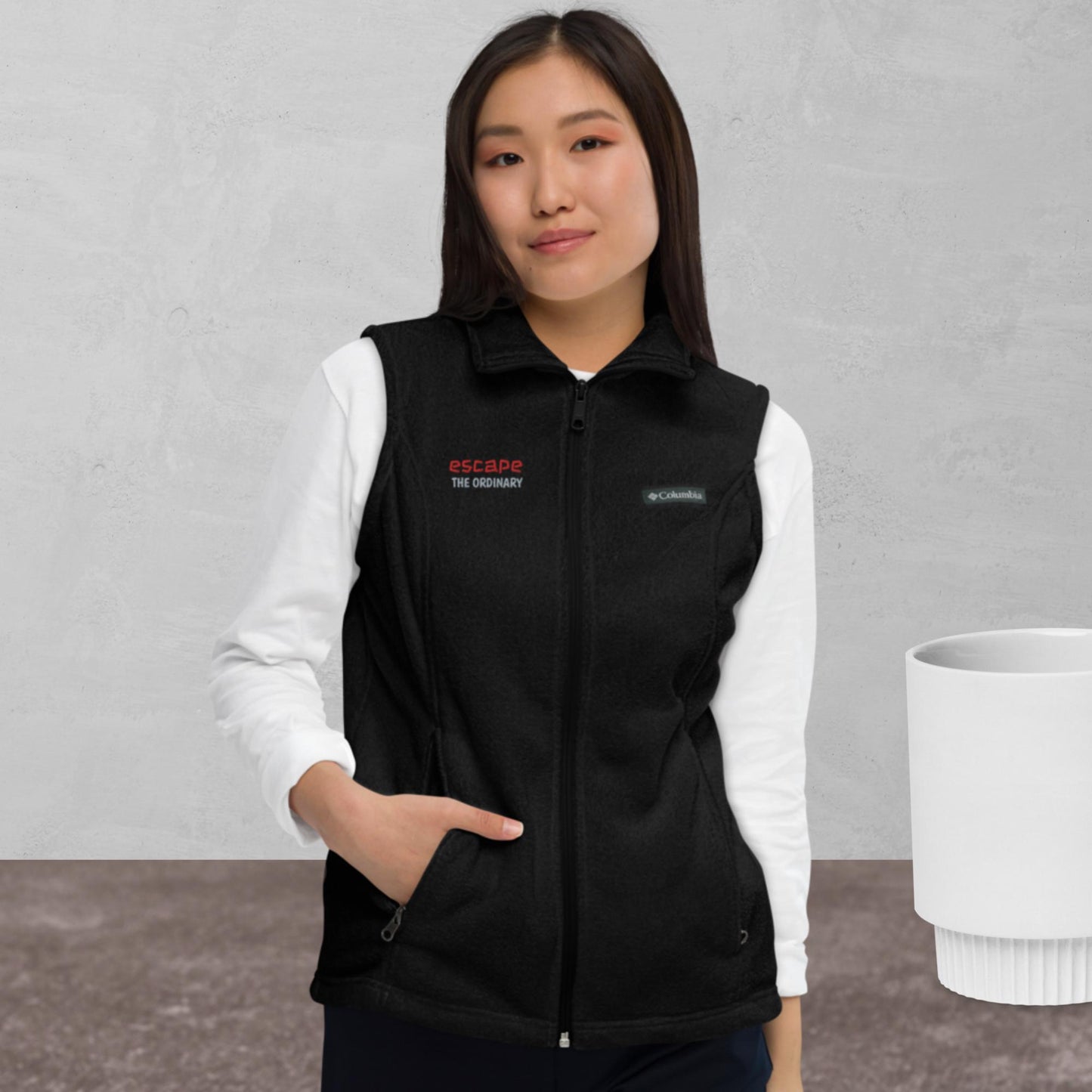 Women’s Columbia fleece vest, red/ grey color thread embroidery, "escape the ordinary", right chest.