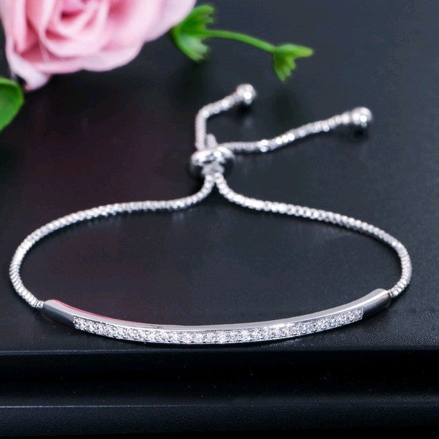 Single row curved bracelet with zircon and diamonds