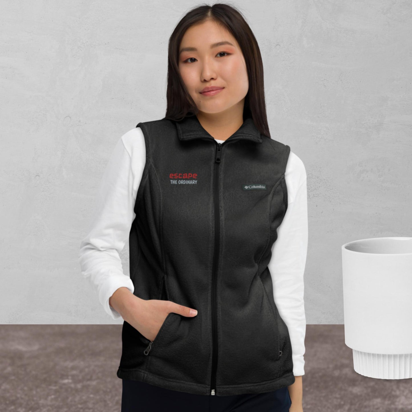 Women’s Columbia fleece vest, red/ grey color thread embroidery, "escape the ordinary", right chest.